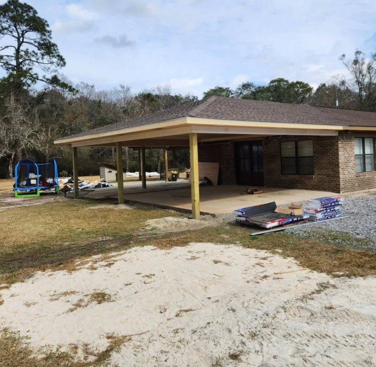 Attached carport and covered patio on a brick home